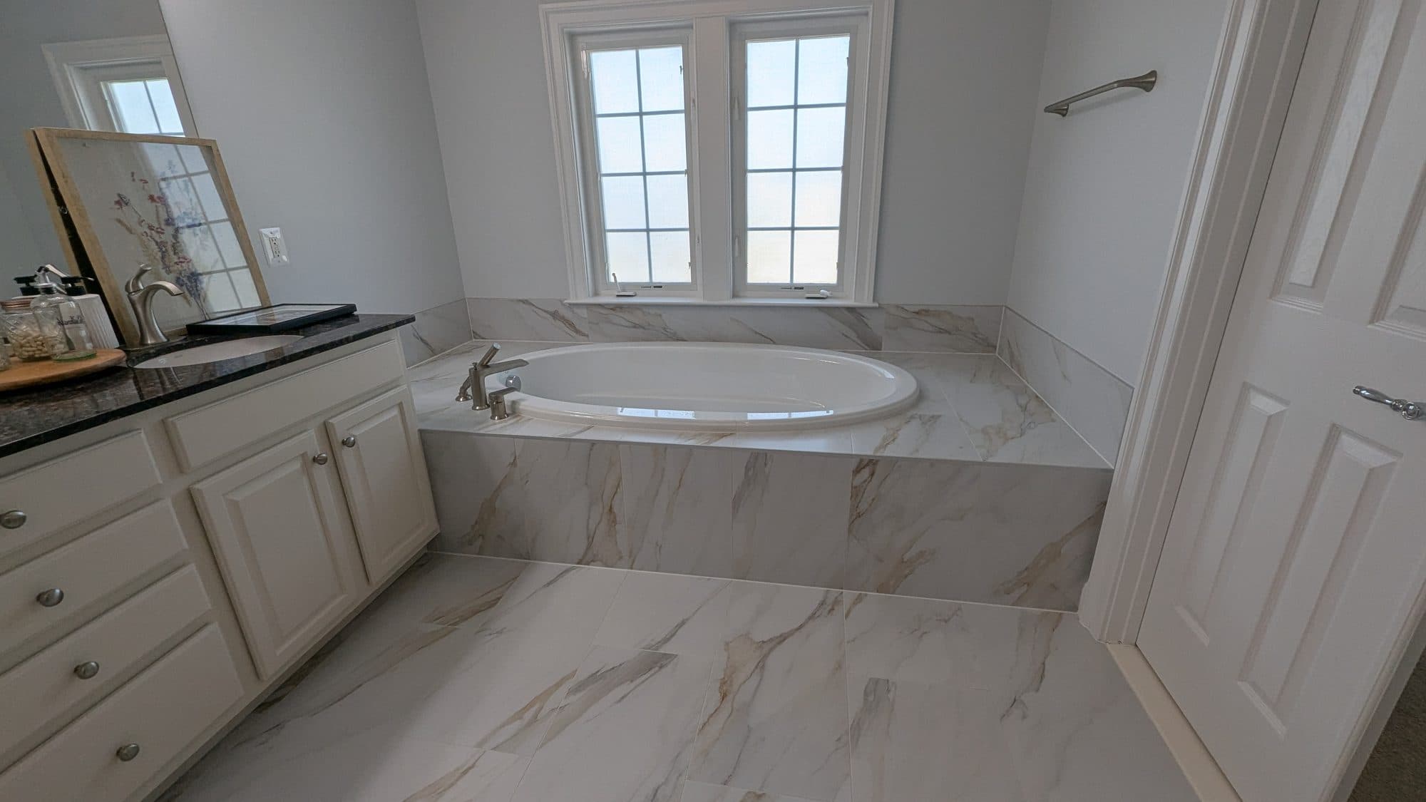 Bathroom with a marble-tiled soaking tub
